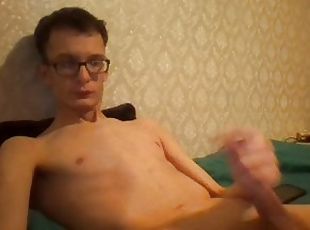 Sexy skinny teen strokes his big cock in front of the camera and cums
