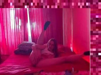 Girl in red room is masturbating her ass