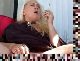 Blonde MILF masturbates outside while smoking