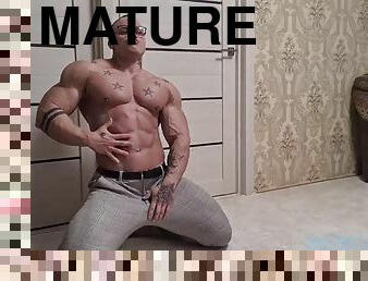 Striptease show of a handsome bodybuilder