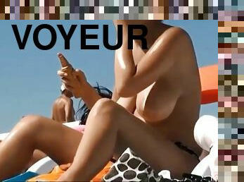 A beach voyeur films topless women