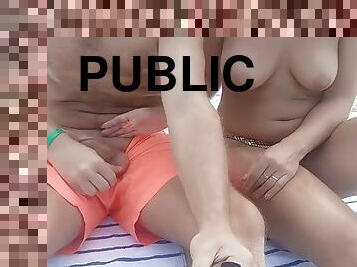 Topless on a public beach walking and jerking off