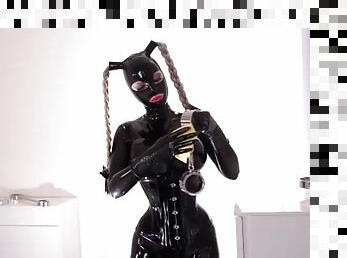 Head to toe latex catsuit on a submissive girl