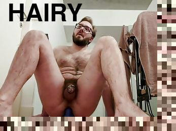 Locked up hairy guy rides his dildo