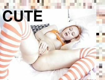 Cute redhead girl in orange stockings beautifully plays with her appetizing pussy