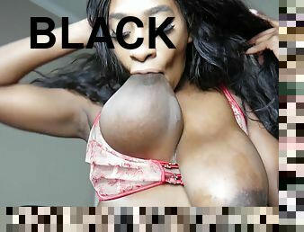 Naughty black girl sucks her big nipple