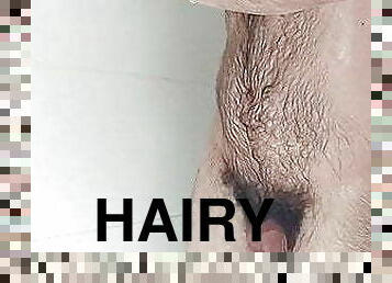 Hairy boy showers and locks up his cock