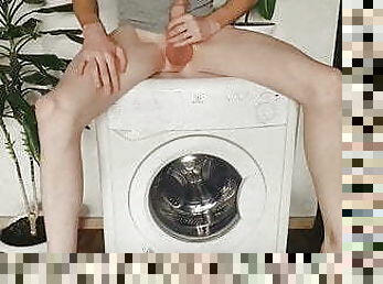 Fit boy jerking on the washmachine