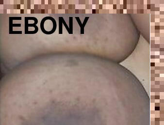 Wanking over her big ebony tits