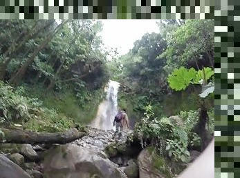 Guy walks trail to waterfall
