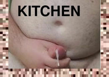 Cumming in front of the kitchen window