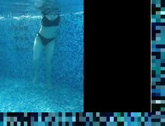 A Russian is swimming in the pool. view of pd with water on a naked girl