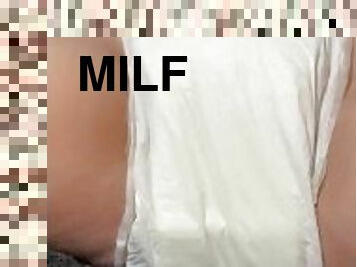 Milf saturates diaper on bed