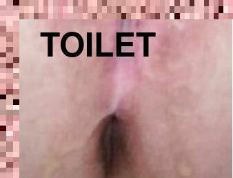 Closeup peeing in the toilet