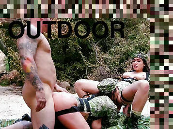Angela White and Karlee Grey in camo outfits take turns on dick outdoors