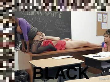 Sexy stocking clad black teacher sits on student's face in the classroom
