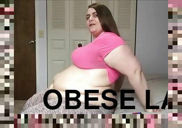 Obese lady eats a small cake