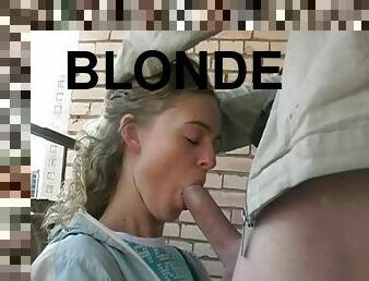 Young blonde sucks on the veranda