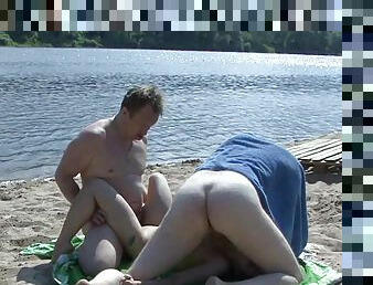 Two fuckers are drilling brunette on the beach