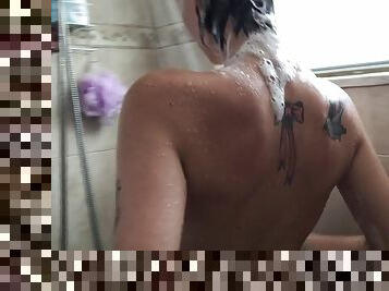 Dark skinned tattooed queen showers slowly while she masturbates harshly