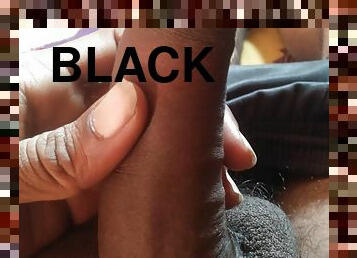 Boy massaging his big black penis with oil
