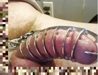 Locked in a metal spiked chastity cage