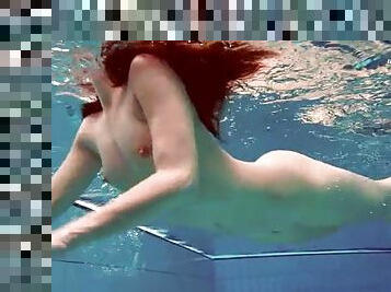 Bikini teen swimming and stripping underwater