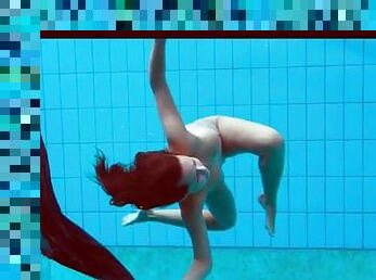Teen strips from her dress in the swimming pool