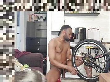 Kennie Jai does a nude bike repair. Watch that big dick swing!!