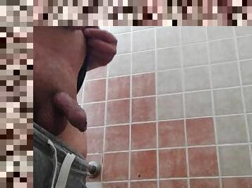 Pissing in a gas station toilet