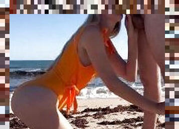 Aussie milf in sexy orange swimsuit at the beach