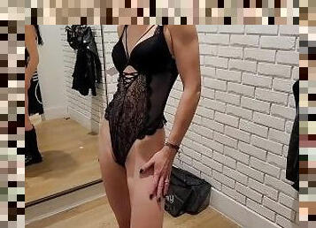 Slim MILF tries on lingerie in the fitting room at the store